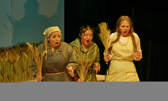 Three women in peasant dress looking surprised.