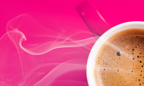 Pink coffee mug on pink background