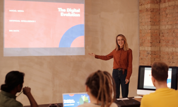 A woman presenting in front of a group of people