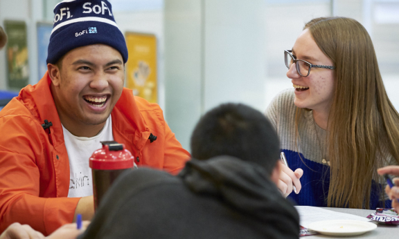 Three students talking and laughing