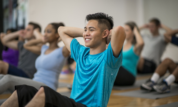 A person doing crunches in a fitness class