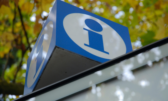 blue and white sign with an I for information