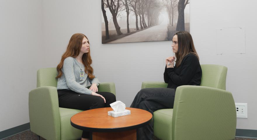 Crying patient in hospital interview room with psych nurse