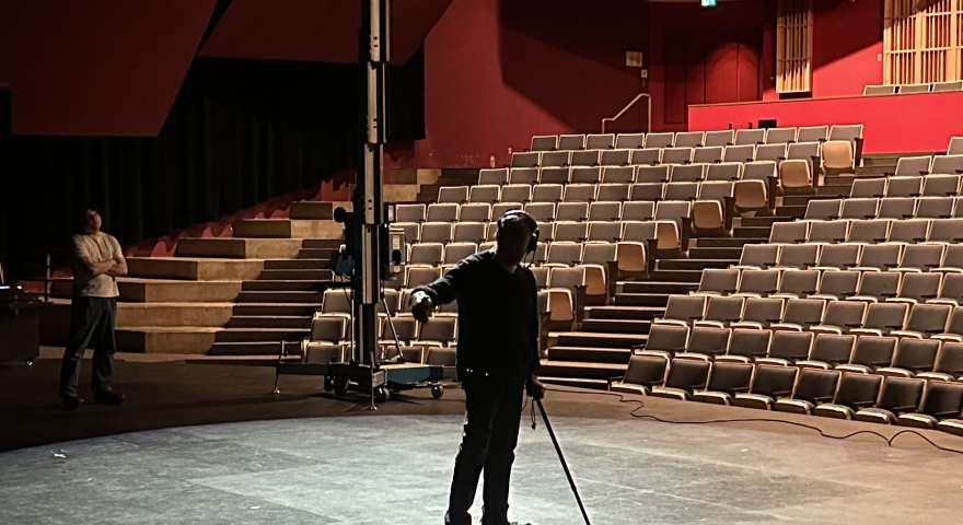 Person sweeping stage