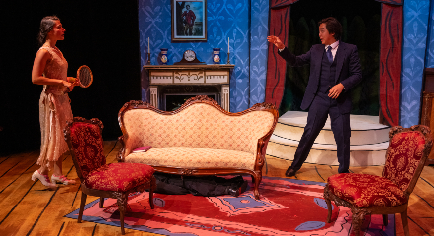 Two people standing near a couch