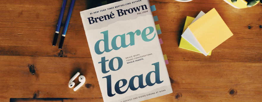 Dare to Lead book by Brené Brown on a wooden table