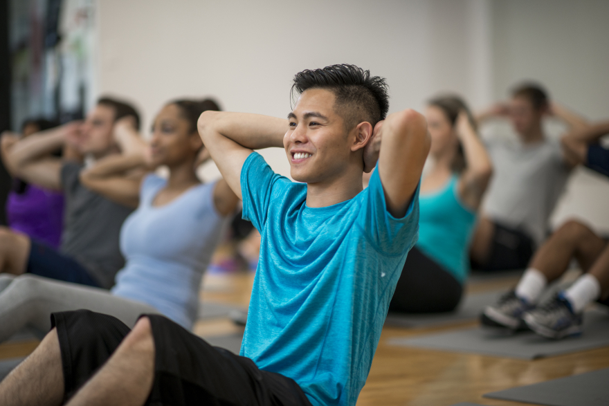A person doing crunches in a fitness class