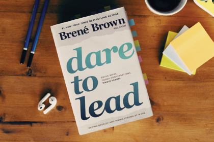 Dare to Lead book by Brené Brown on a wooden table
