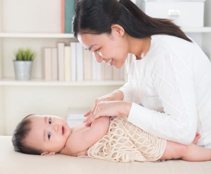 A woman doing massage for her baby