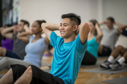 A group of people doing exercises on the mats in a gym