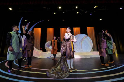 Actors on a stage in period costumes