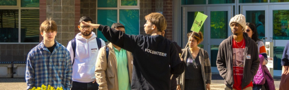 A volunteer leading a campus tour