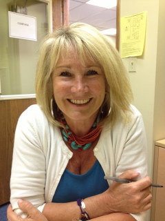 Blond woman smiling in an office