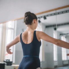 Dancer looks at the mirror while dancing.