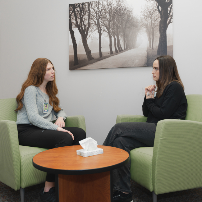 Crying patient in hospital interview room with psych nurse