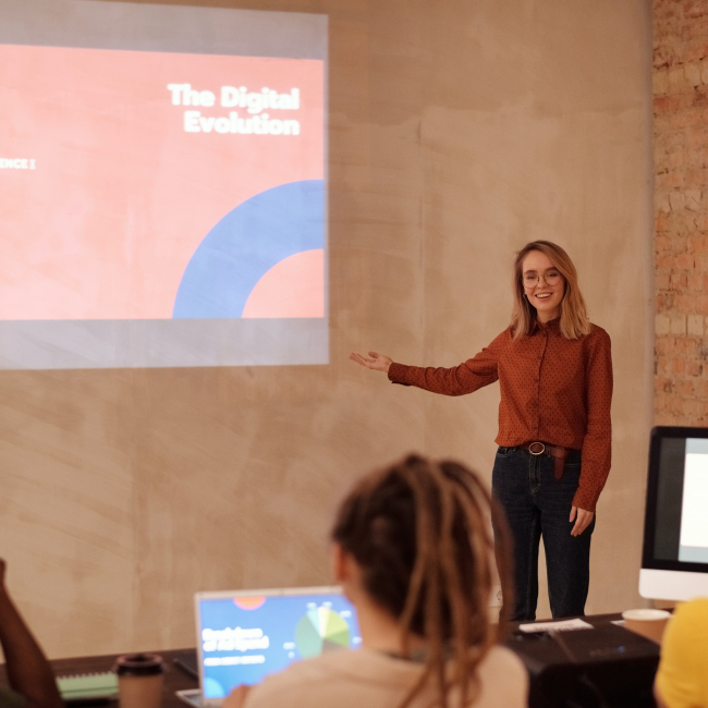 A woman presenting in front of a group of people