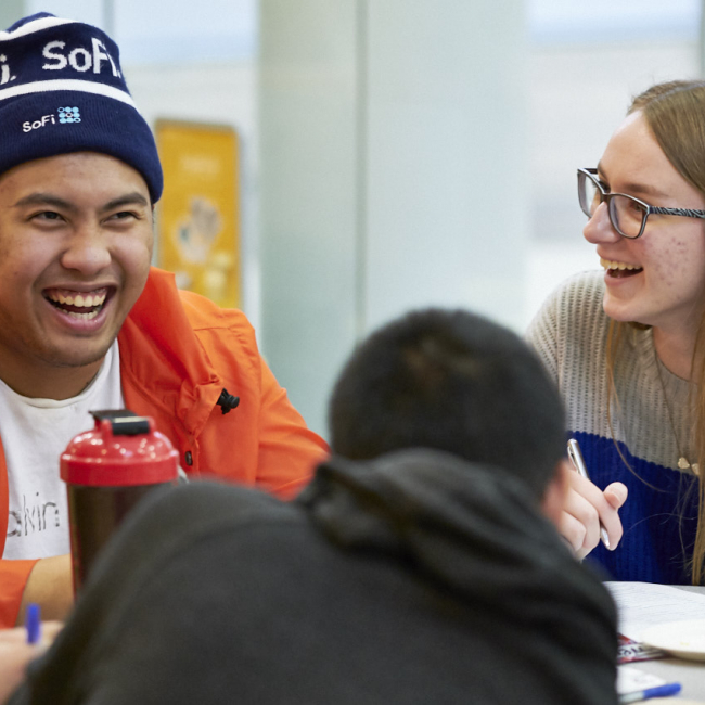 Three students talking and laughing