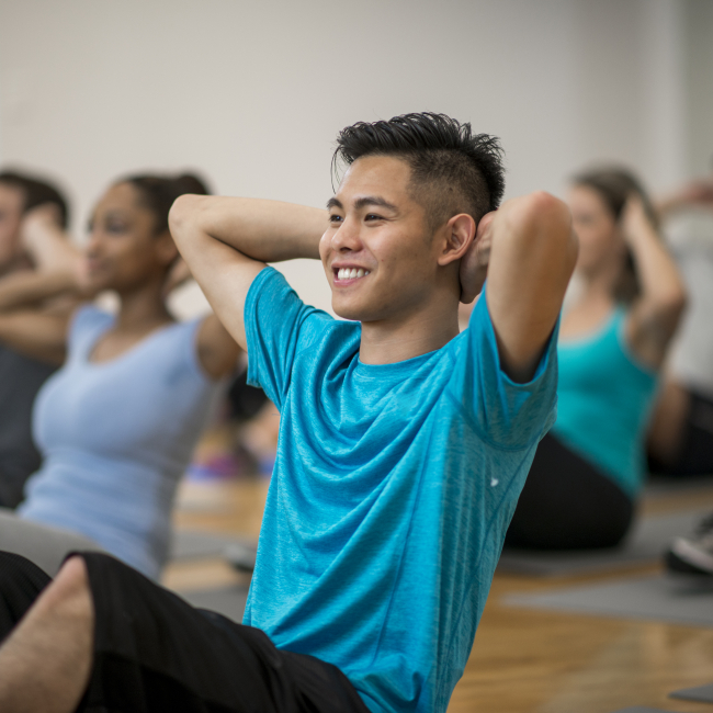 A person doing crunches in a fitness class