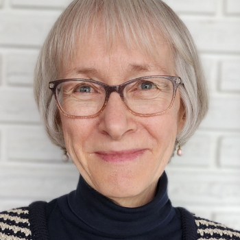 Photo of Ruth Enns with white brick wall in the background