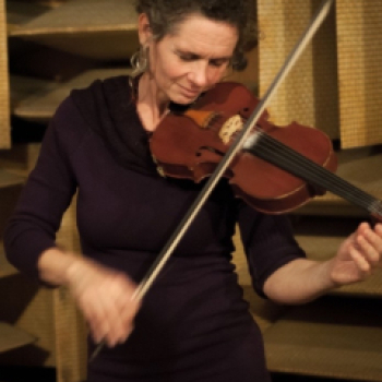 Photograph of Hazel Fairbairn playing the violin in studio