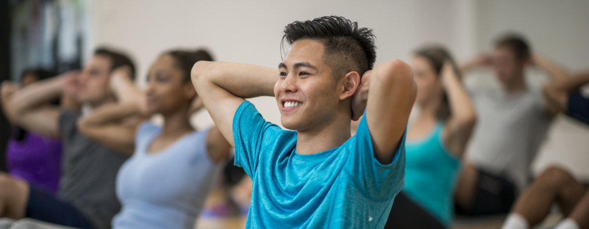 A group of people doing exercises on the mats in a gym